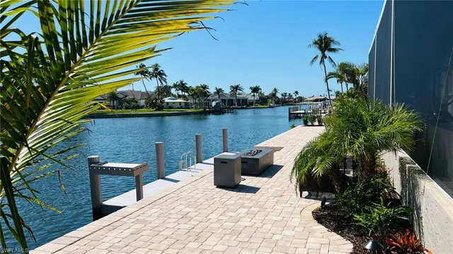 a view of a lake with couches and wooden floor