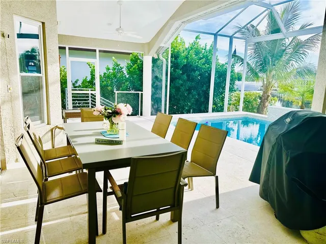 a view of an outdoor dining space with a table and chairs