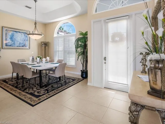 a dining room with fireplace furniture and a potted plant
