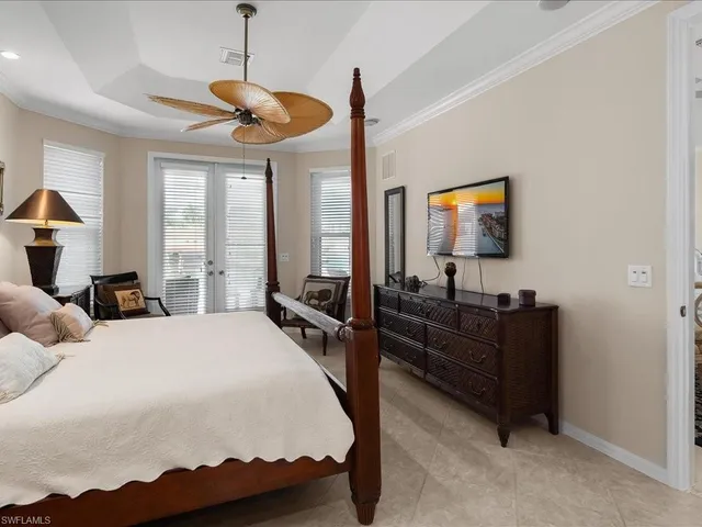 a bedroom with furniture and a flat screen tv