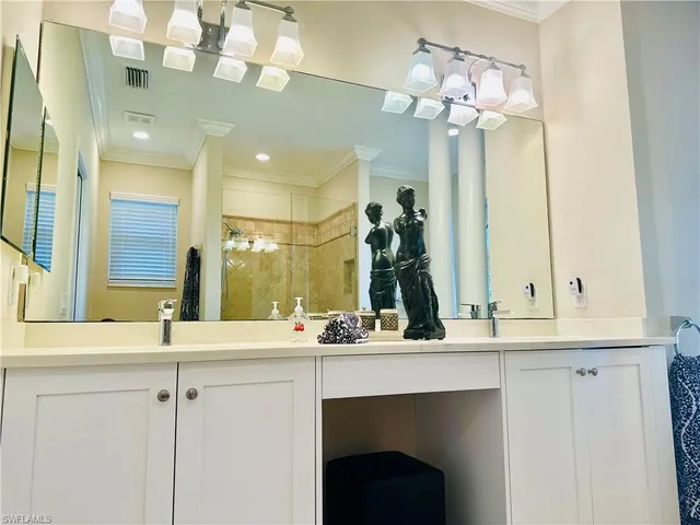 a bathroom with a sink vanity and a mirror