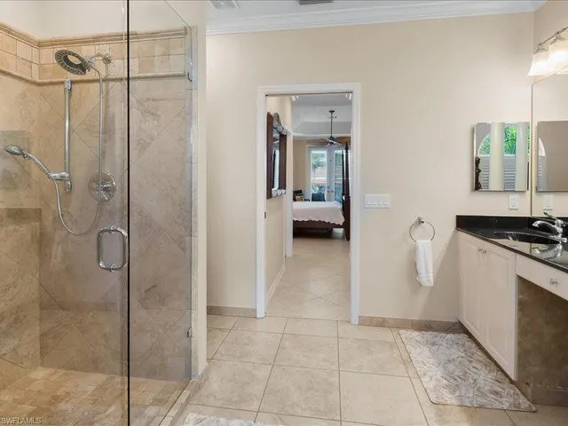 a en suite bathroom with a granite countertop shower