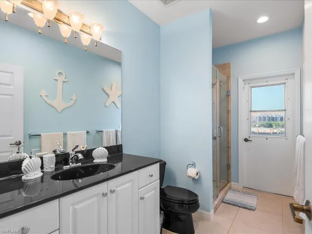 a bathroom with a sink a mirror and a toilet