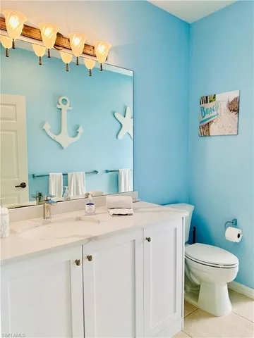 a bathroom with a sink a toilet and mirror
