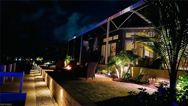 a view of a roof deck with table and chairs and potted plants