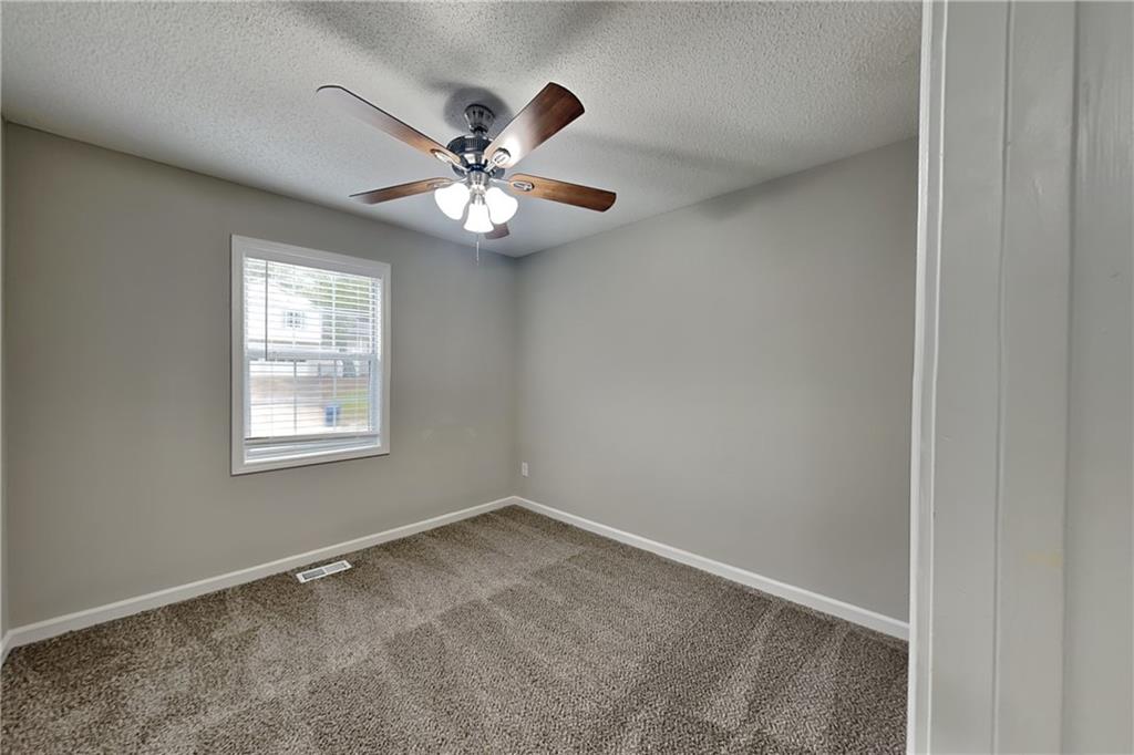 214 Brookside Drive Dallas, GA 30132 - Photo 13 of 20 a view of an empty room with chandelier fan