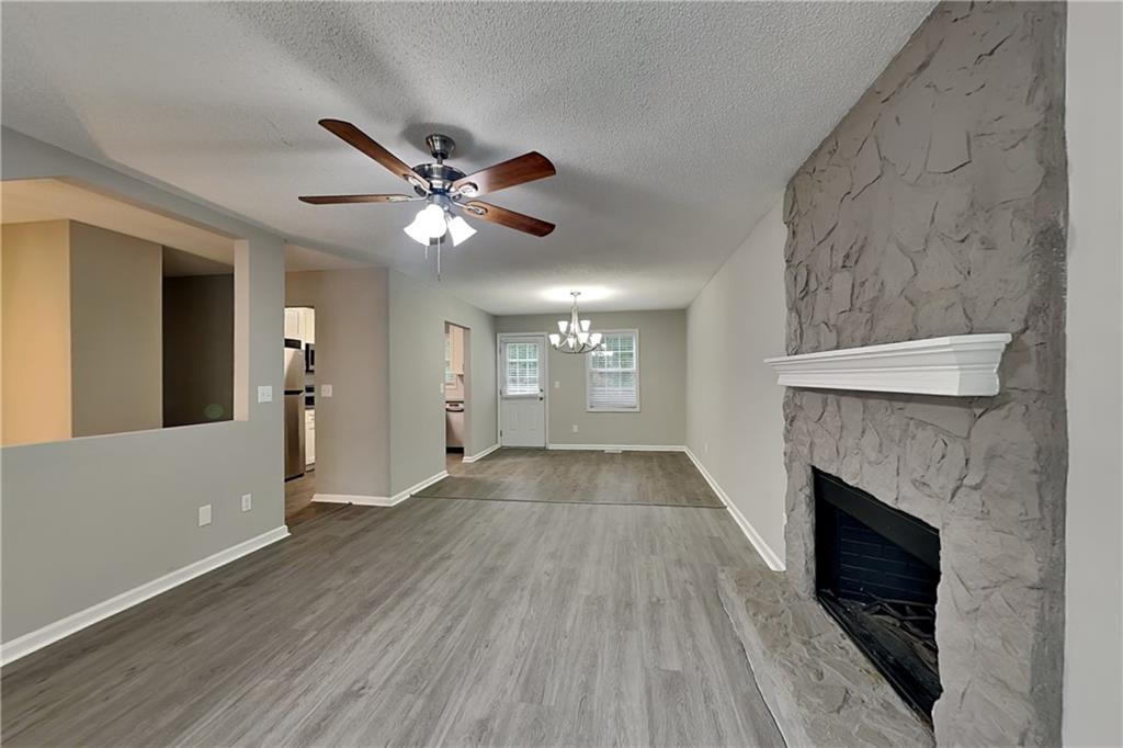 214 Brookside Drive Dallas, GA 30132 - Photo 17 of 20 a view of an empty room with wooden floor and a fireplace