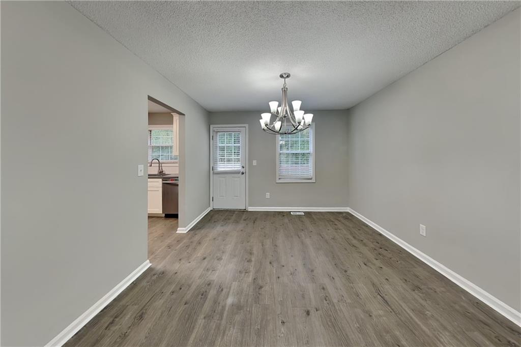 214 Brookside Drive Dallas, GA 30132 - Photo 18 of 20 wooden floor in an empty room with a window