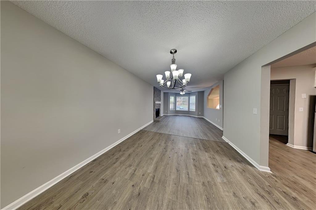 214 Brookside Drive Dallas, GA 30132 - Photo 4 of 20 a view of a room with wooden floor and chandelier