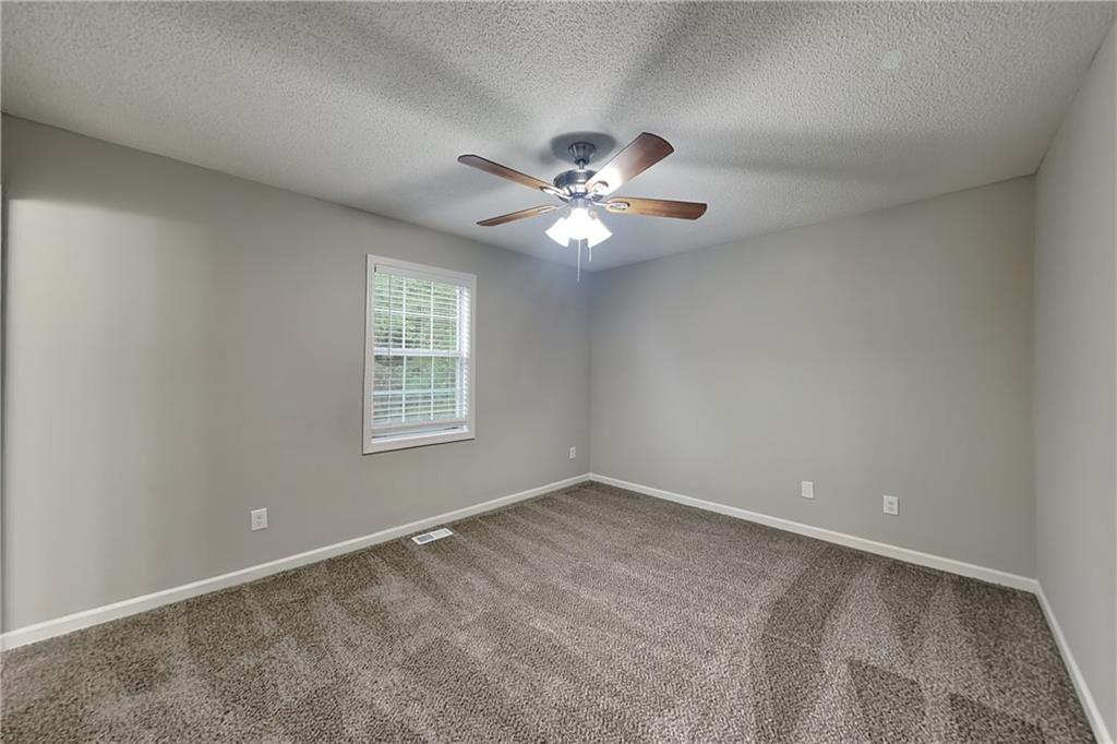 214 Brookside Drive Dallas, GA 30132 - Photo 6 of 20 a view of an empty room with a ceiling fan