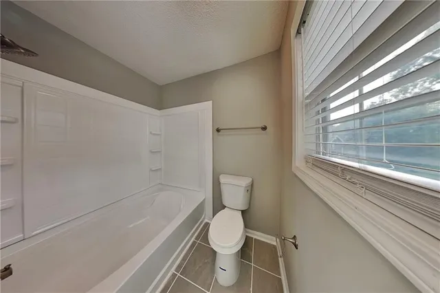 a bathroom with a toilet and a bathtub