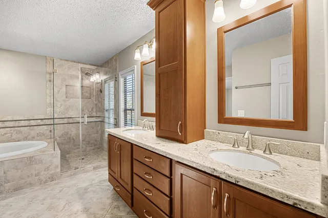 a bathroom with a granite countertop sink mirror and double