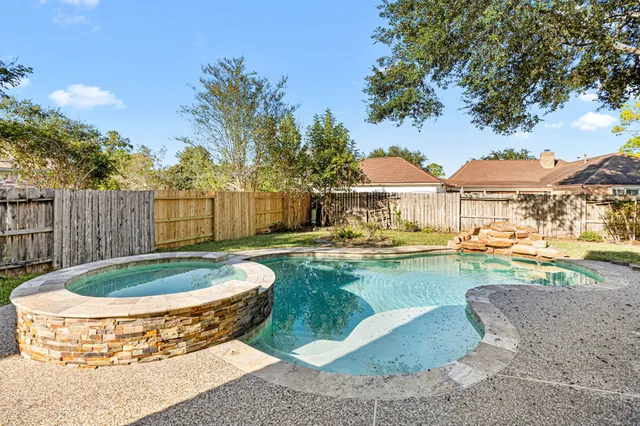 a view of a swimming pool with a patio