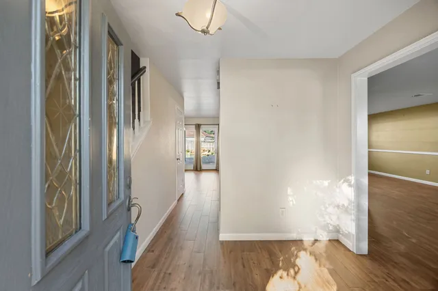 a view of a hallway with wooden floor