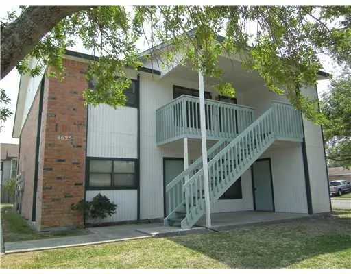 a view of balcony with small plants and wooden fence