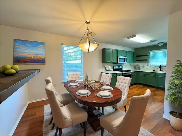 a kitchen with granite countertop stainless steel appliances and wooden cabinets