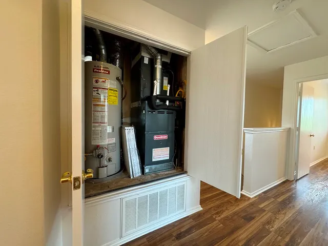a view of a room with wooden floor and a window
