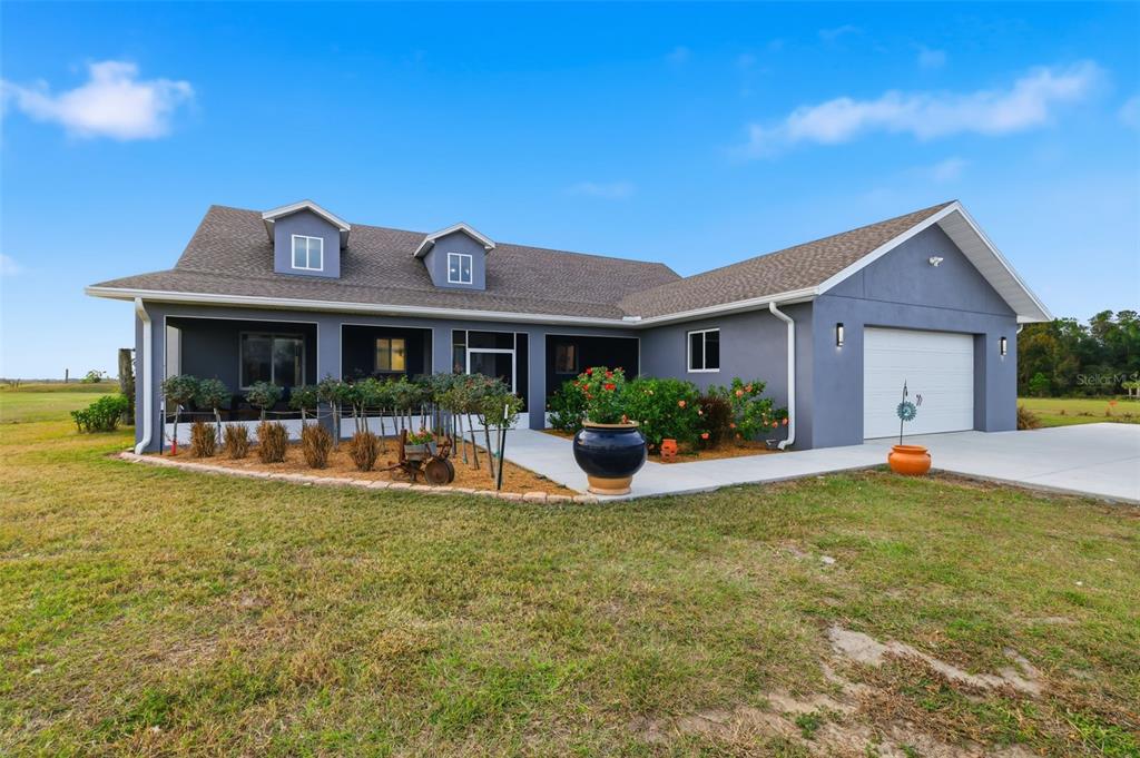 a view of a house with swimming pool and a yard