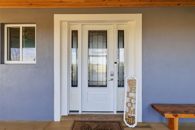 a bathroom with a sink and mirror with shower