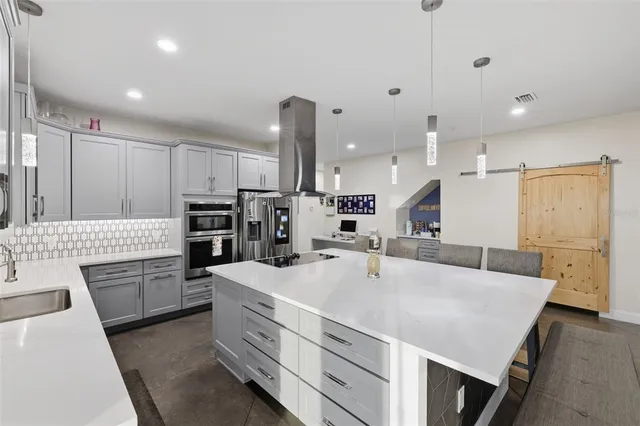 a bedroom with a bed a couch and a large window