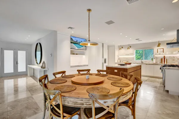 a kitchen with a sink a stove cabinets and a refrigerator