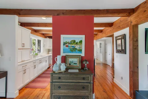 a bed sitting in a spacious bedroom next to a window