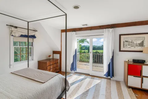 a balcony with wooden floor and fence