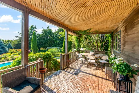 a patio with yard glass top table and chairs