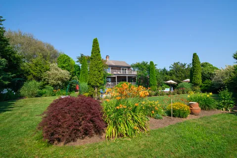 a view of a house with a garden and yard