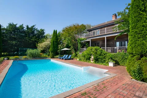 front view of a house with yard and trees