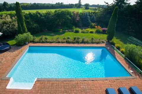 a backyard of a house with plants and tree