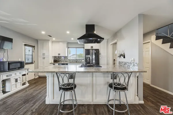 a kitchen with stainless steel appliances granite countertop a stove and a sink