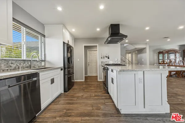 a living room with furniture a wooden floor and a window