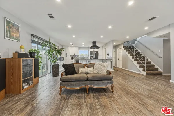 a bathroom with a walk in closet and wooden floor