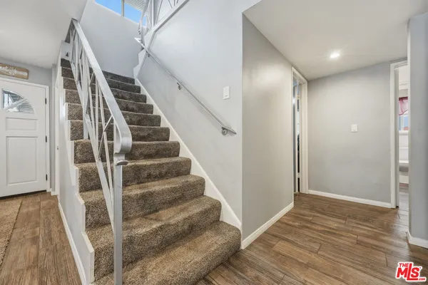 a view of a room with wooden floor and windows