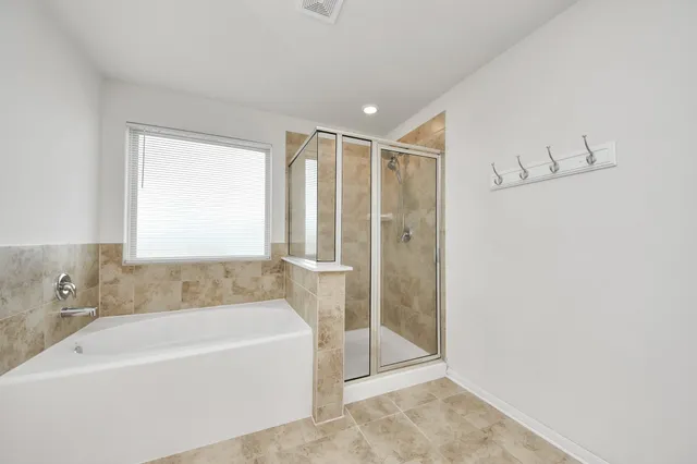 a bathroom with a bathtub and a shower