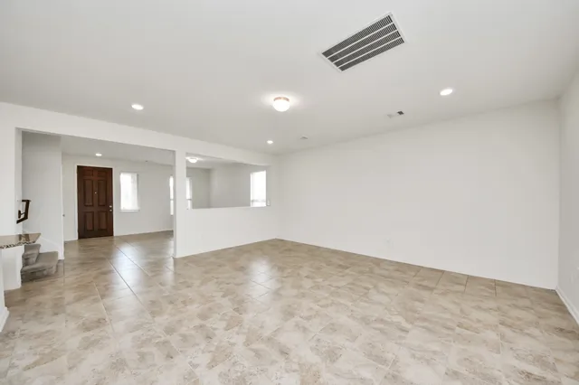 an empty room with windows and pillars in it