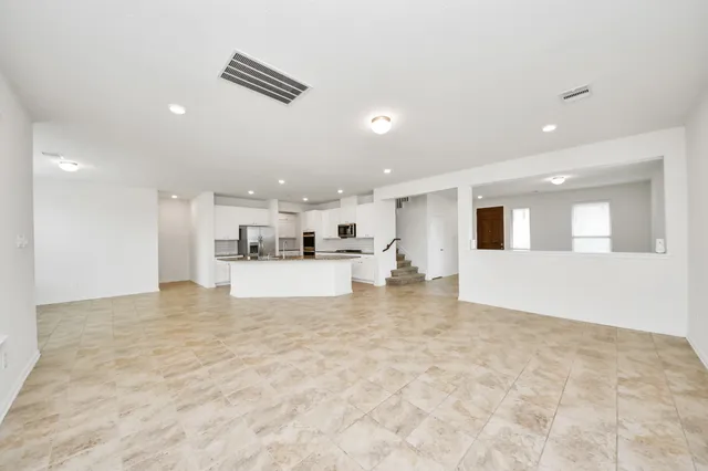 a view of kitchen with kitchen island microwave and stove