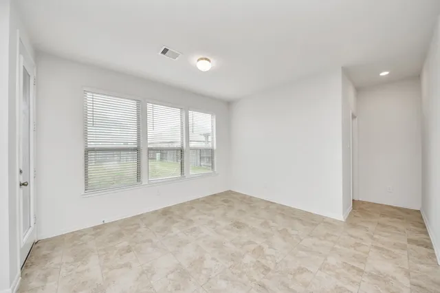 a view of an empty room with a window