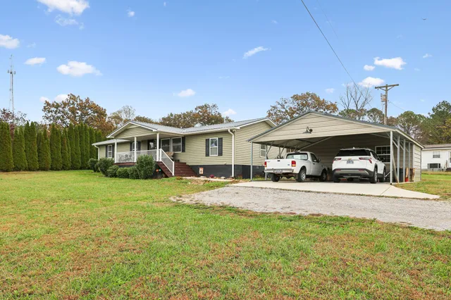 a front view of a house with a yard and porch