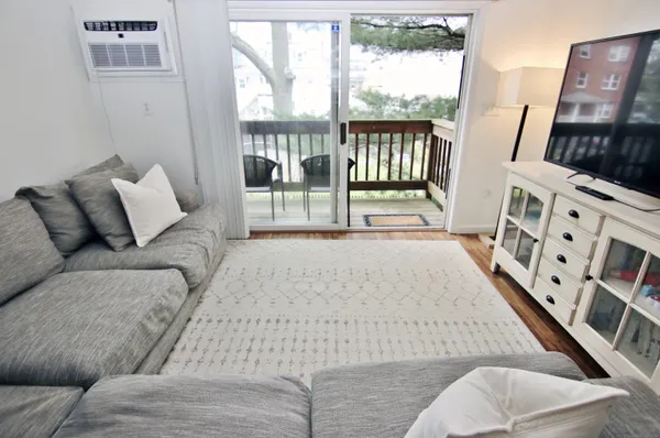 a living room with furniture and a floor to ceiling window