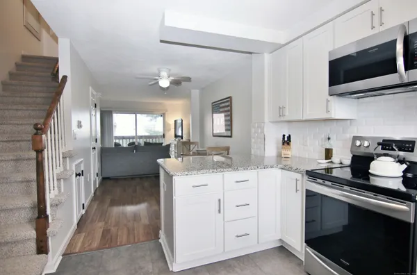 a kitchen with a sink stove and microwave