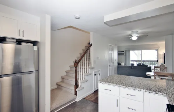 a kitchen with white cabinets and sink