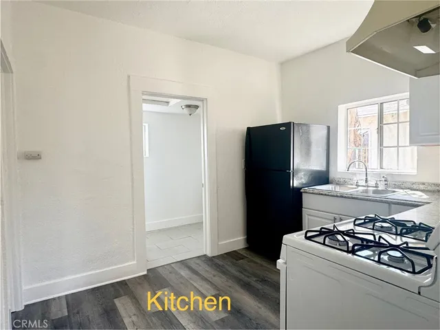 a kitchen with a refrigerator and a stove