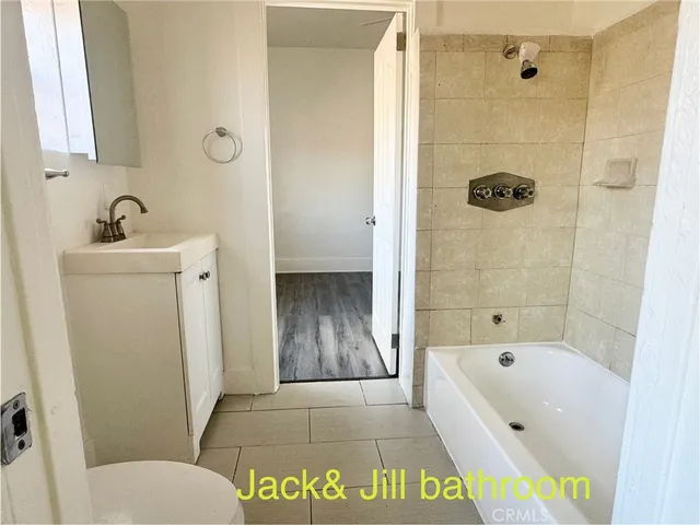 a bathroom with a tub a sink and a shower