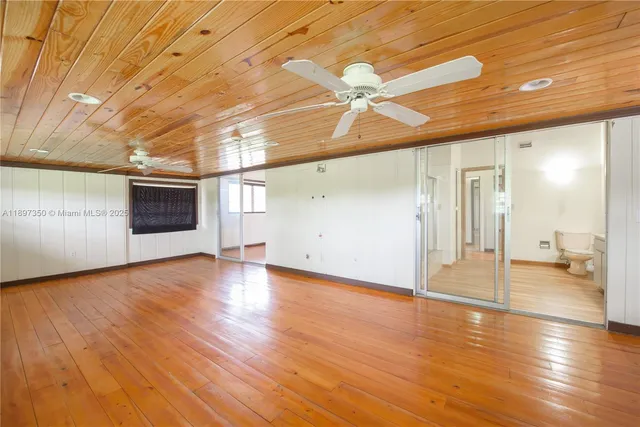 a bathroom with a sink mirror vanity and toilet