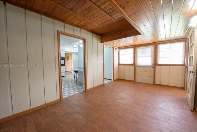 a view of a room with wooden floor and a window