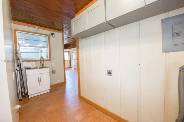 a kitchen with stainless steel appliances a sink a stove a refrigerator and cabinets