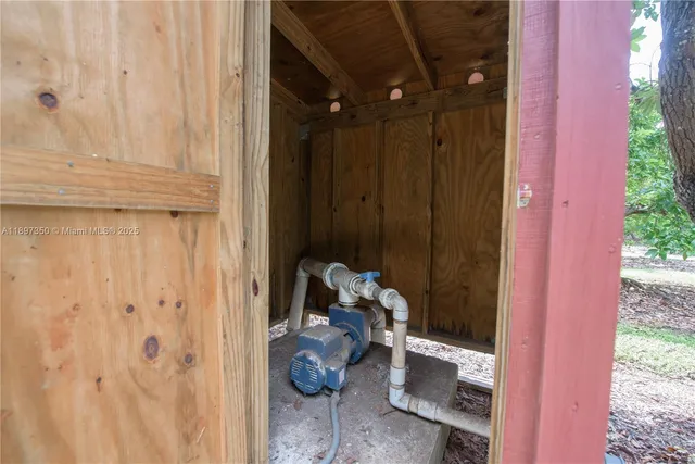 a view of a house with a big yard and large tree