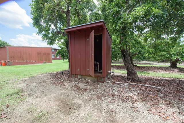 an aerial view of a house with backyard space and garden